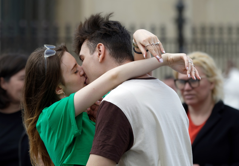 Young couple kissing in a public place